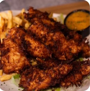 Crispy Coconut Chicken served with mango chutney dipping sauce at Fire & Feast in Commerce Township, Michigan.
