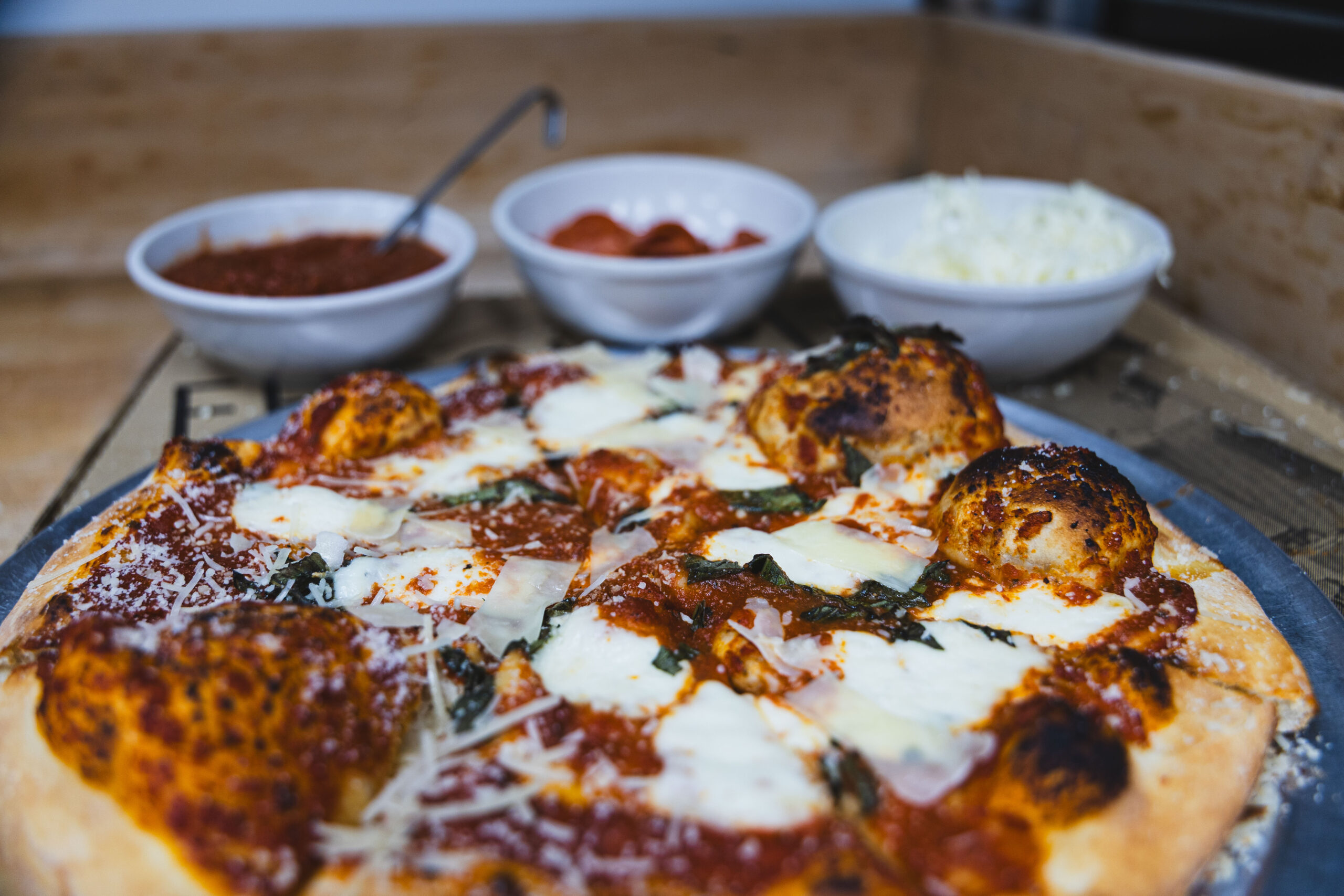 Fire & Feast Gourmet Pizza made with fresh dough, premium toppings, and melted mozzarella cheese in Commerce Township, Michigan.