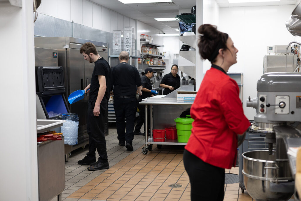 Fire & Feast catering staff preparing and organizing food for a large catering event in Commerce Township, Michigan.