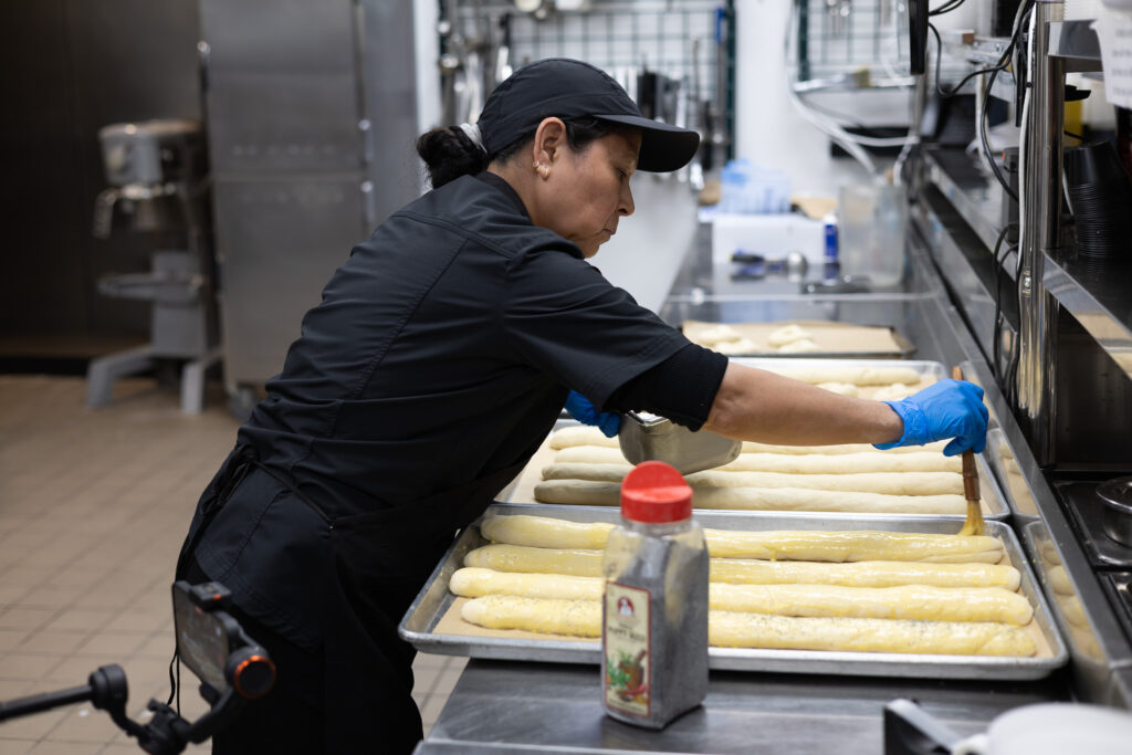 Fire & Feast staff preparing and baking fresh bread for a catering event in Commerce Township, Michigan.