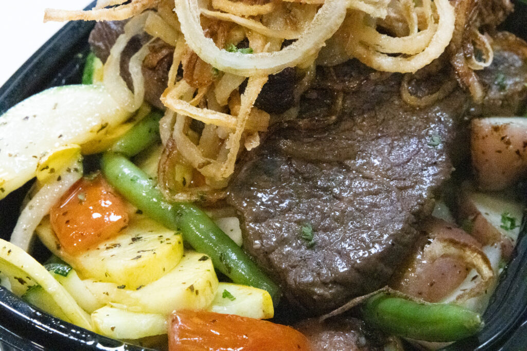 Slow-braised beef short ribs served with rich gravy and tender vegetables at Fire & Feast in Commerce Township, Michigan.