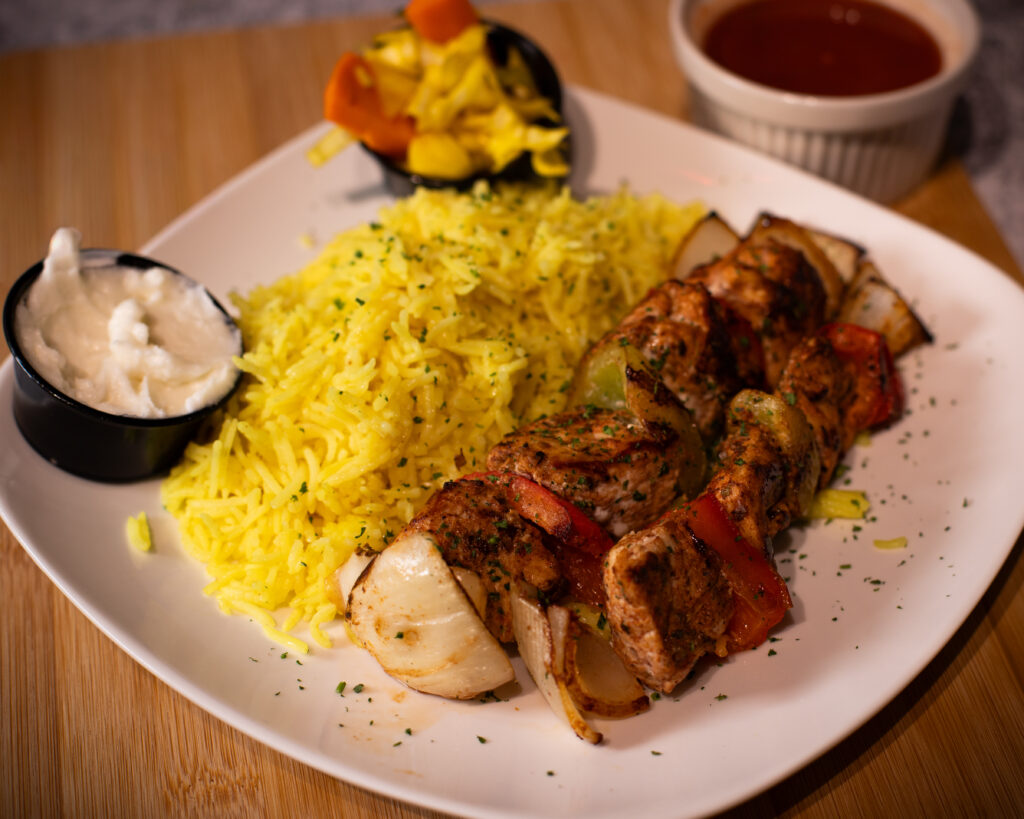 Fire & Feast Chicken Breast Tikka served with seasoned yellow rice in Commerce Township, Michigan.