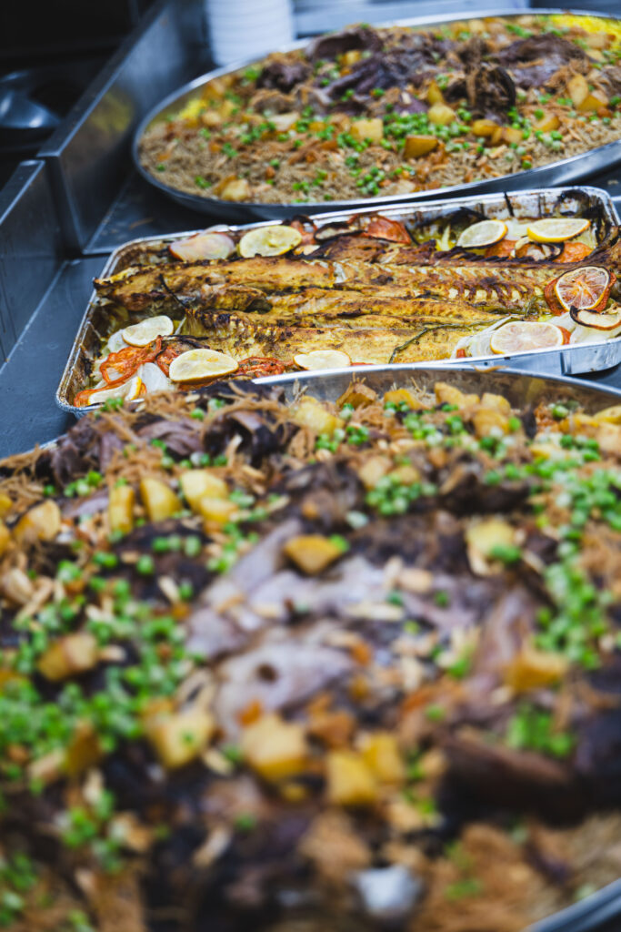 Fire & Feast Quzi and Masgoof featuring slow-roasted lamb and traditional grilled fish served with seasoned rice in Commerce Township, Michigan.